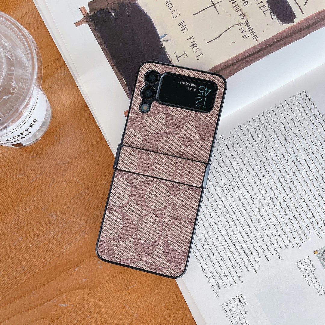Coach Z Flip/Z Fold Samsungin puhelinkotelo sormihihnalla