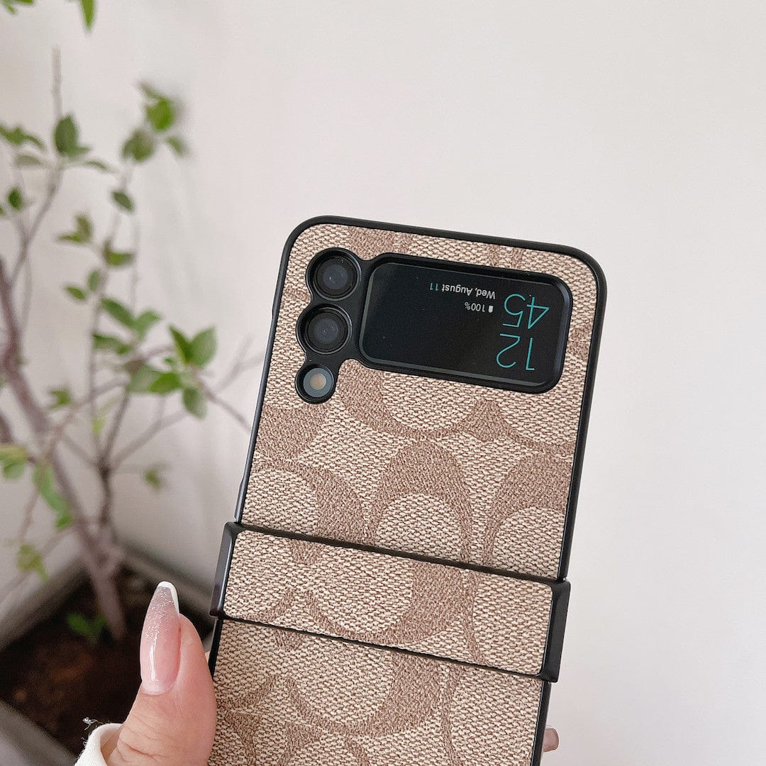Coach Z Flip/Z Fold Samsungin puhelinkotelo sormihihnalla